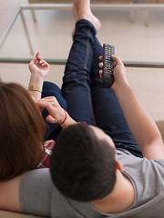 Image showing Young couple on the sofa watching television