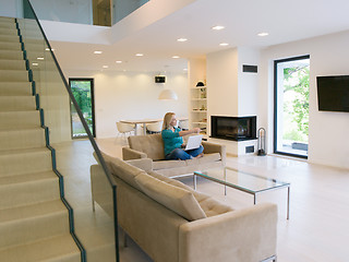 Image showing Young woman using laptop at home