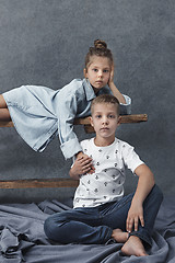 Image showing A portrait of little girl and a boy on the gray background