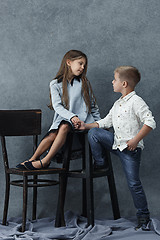 Image showing A portrait of little girl and a boy on the gray background