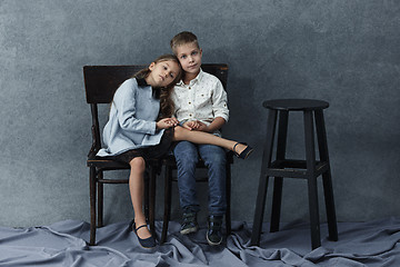 Image showing A portrait of little girl and a boy on the gray background