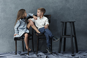 Image showing A portrait of little girl and a boy on the gray background