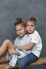 Image showing A portrait of little girl and a boy on the gray background