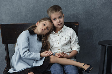 Image showing A portrait of little girl and a boy on the gray background