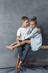 Image showing A portrait of little girl and a boy on the gray background