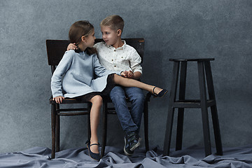 Image showing A portrait of little girl and a boy on the gray background