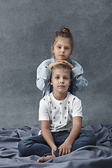 Image showing A portrait of little girl and a boy on the gray background