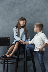 Image showing A portrait of little girl and a boy on the gray background