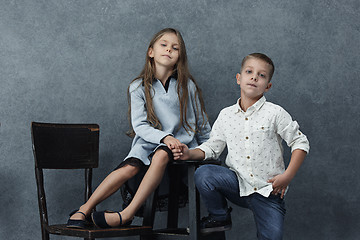 Image showing A portrait of little girl and a boy on the gray background