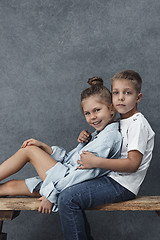 Image showing A portrait of little girl and a boy on the gray background