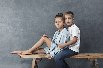 Image showing A portrait of little girl and a boy on the gray background