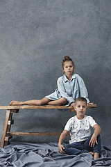 Image showing A portrait of little girl and a boy on the gray background