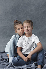 Image showing A portrait of little girl and a boy on the gray background