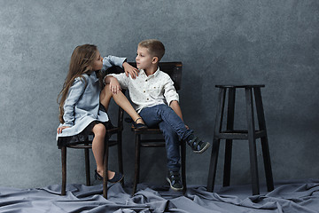 Image showing A portrait of little girl and a boy on the gray background