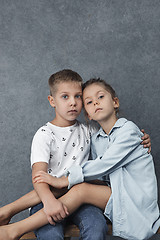 Image showing A portrait of little girl and a boy on the gray background