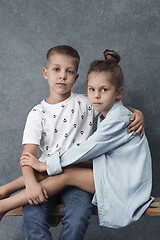 Image showing A portrait of little girl and a boy on the gray background