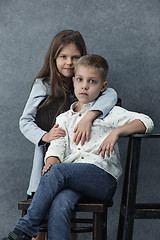 Image showing A portrait of little girl and a boy on the gray background