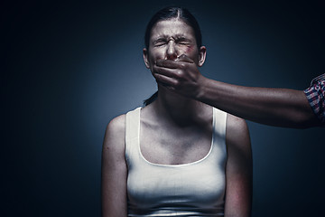 Image showing Man covering young woman\'s mouth