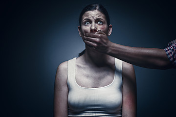 Image showing Man covering young woman\'s mouth