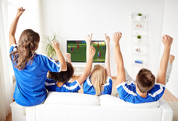 Image showing football fans watching soccer game on tv at home
