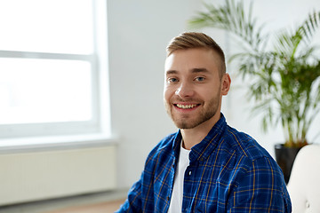 Image showing portrait of happy smiling young man at office