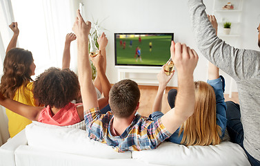 Image showing friends with beer watching soccer on tv at home