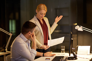 Image showing business team with papers working late at office