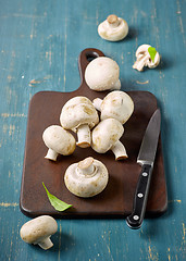 Image showing fresh mushrooms on wooden cutting board