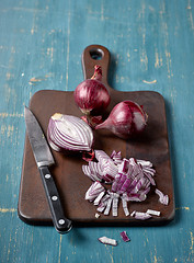 Image showing red onion on wooden cutting board