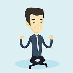 Image showing Business man meditating in lotus position.