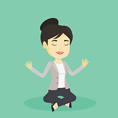 Image showing Business woman meditating in lotus position.