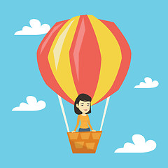 Image showing Asian woman flying in hot air balloon.