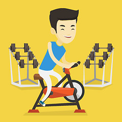 Image showing Young man riding stationary bicycle.