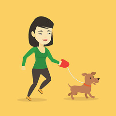 Image showing Young woman walking with her dog.