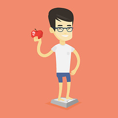 Image showing Man standing on scale and holding apple in hand.