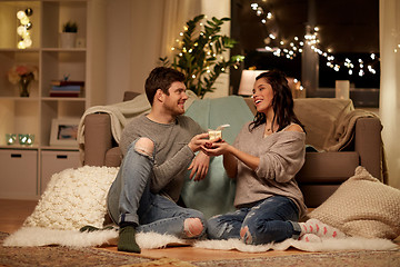 Image showing happy couple with gift box at home