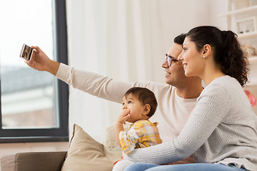 Image showing mother and father with baby taking selfie at home