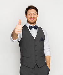 Image showing happy man in festive suit showing thumbs up