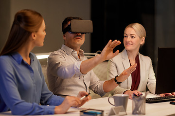 Image showing business team with computer working late at office