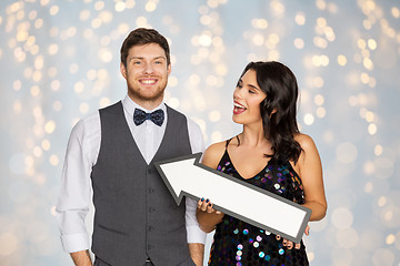 Image showing happy couple with big arrow at party