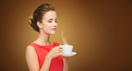 Image showing beautiful woman in red dress with cup of coffee