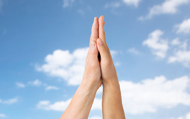 Image showing close up of senior and young woman touching hands