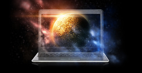 Image showing laptop with virtual planet and space hologram