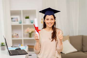 Image showing student with diploma at home showing thumbs up