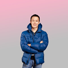 Image showing Asian man in blue down-padded coat