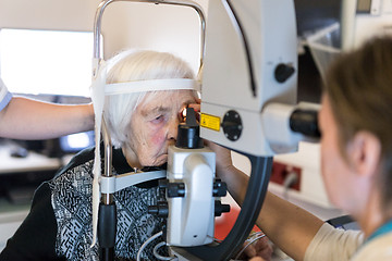 Image showing Senior woman during laser surgery at ophthalmology clinic.