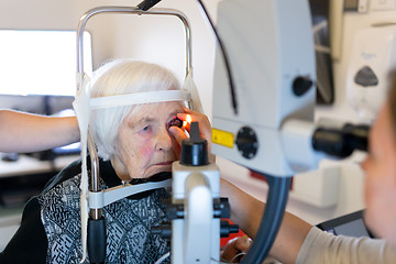 Image showing Senior woman during laser surgery at ophthalmology clinic.