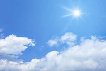 Image showing bright blue sky with sun and clouds background