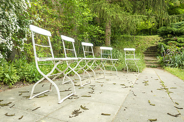 Image showing five chairs outside in the green garden