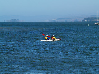 Image showing two-man kayak on bay with moored sailboat